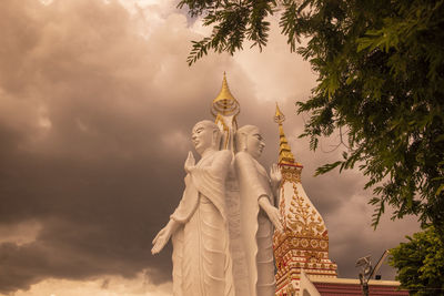 Low angle view of temple against cloudy sky