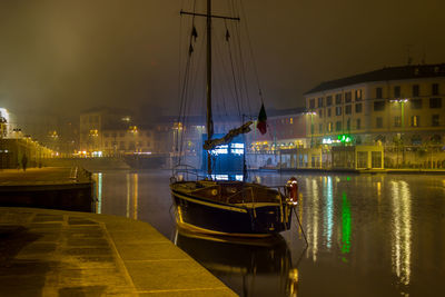 Boats in harbor at night