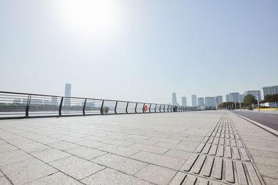 Empty sidewalk with city skyline near the bay in binjiang, china.