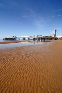 Scenic view of beach against blue sky