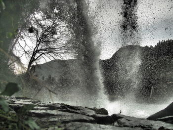Scenic view of waterfall against sky