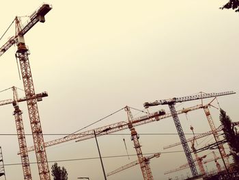 Low angle view of crane against sky