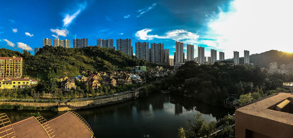 Panoramic view of city against cloudy sky