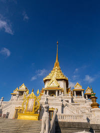 Low angle view of temple building against blue sky