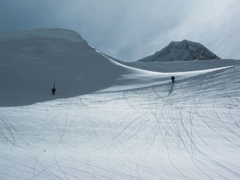 Ski mountaineers roped up on a snow covered mountain