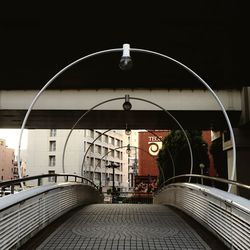 Empty road amidst buildings in city