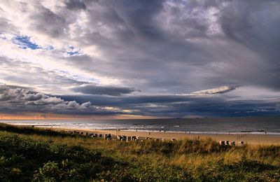 Scenic view of sea against cloudy sky