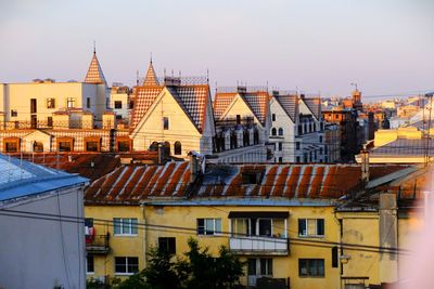 Buildings in city against clear sky