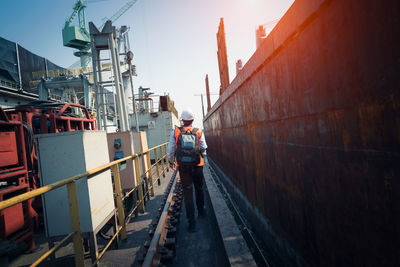 Man working at construction site against sky