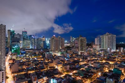 High angle view of illuminated city buildings against sky