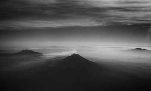 Scenic view of mountains against cloudy sky