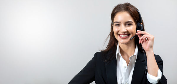 Portrait of a smiling young woman using smart phone