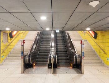 Low angle view of illuminated steps in subway station
