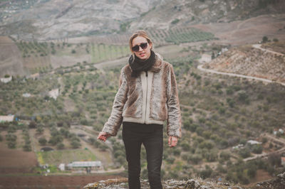 Portrait of young woman standing outdoors