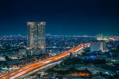 Aerial view of illuminated buildings in city at night