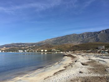 Scenic view of beach against blue sky