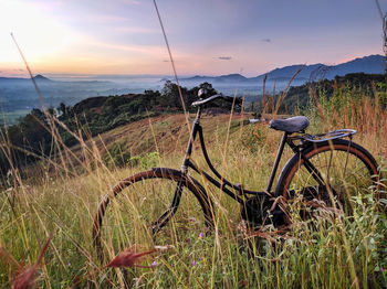 Bicycles on field against sky