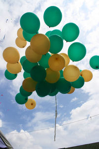 Low angle view of balloons against sky