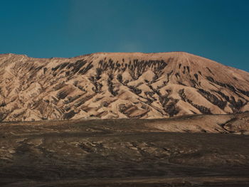 Scenic view of arid landscape against sky