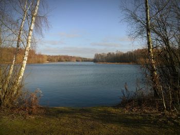 Scenic view of calm lake against sky