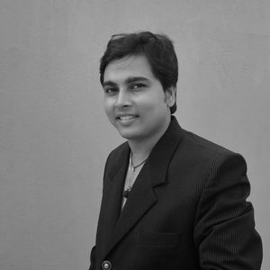 Portrait of young man standing against wall