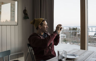 Man taking pictures of the view from his balcony at home in sweden