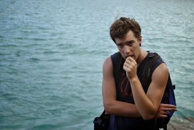 Portrait of young man looking at sea