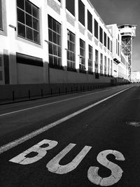Arrow sign on road in city