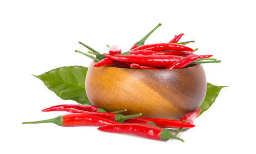 Close-up of red chili pepper against white background