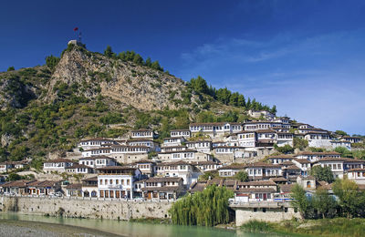 Buildings in town against sky