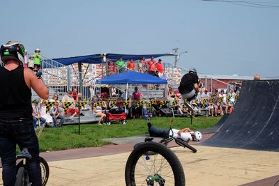 People riding bicycle on street in city