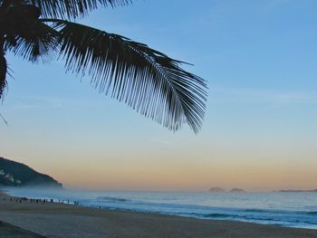 Scenic view of beach against blue sky