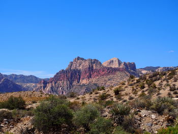 Scenic view of rocky mountains against clear blue sky