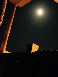 Low angle view of illuminated lights against sky at night