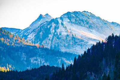 Low angle view of snowcapped mountains against sky