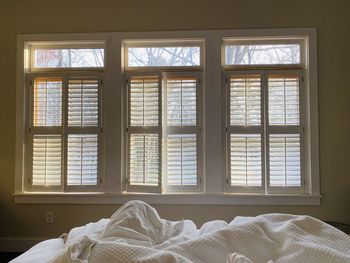 View of messy bed by window