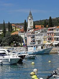 Boats in river with buildings in background