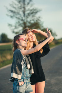 Girl gesturing by friend in city