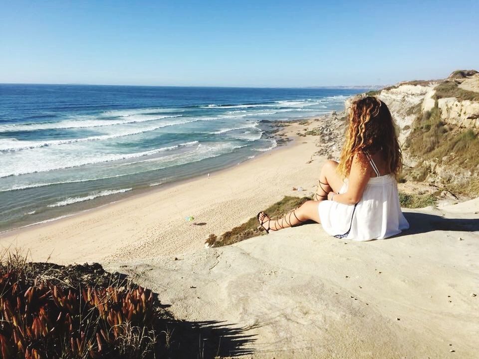 sea, beach, horizon over water, shore, water, sand, lifestyles, leisure activity, young adult, vacations, young women, clear sky, scenics, person, full length, tranquil scene, tranquility, beauty in nature