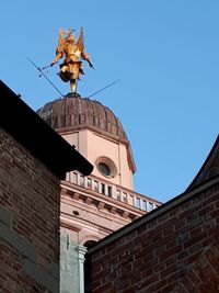 Low angle view of statue against building