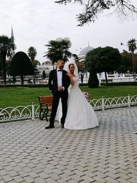 Full length of a smiling young woman outdoors