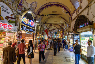 Group of people walking in illuminated city