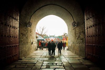 People in corridor of city