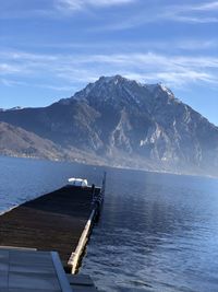 Scenic view of sea and mountains against sky