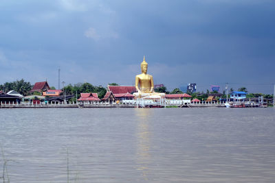 View of church by sea against sky