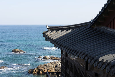 Panoramic view of sea and building against clear sky