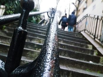 Close-up of wet railing on staircase