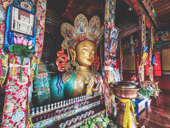 Low angle view of buddha statue against building