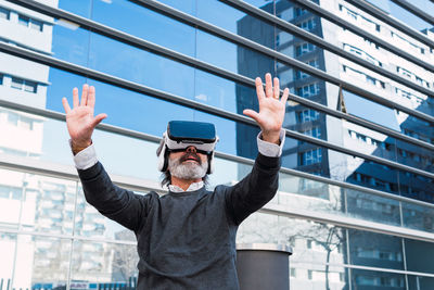 Digital composite image of man standing against building