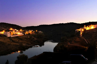 Reflection of illuminated buildings in water at night